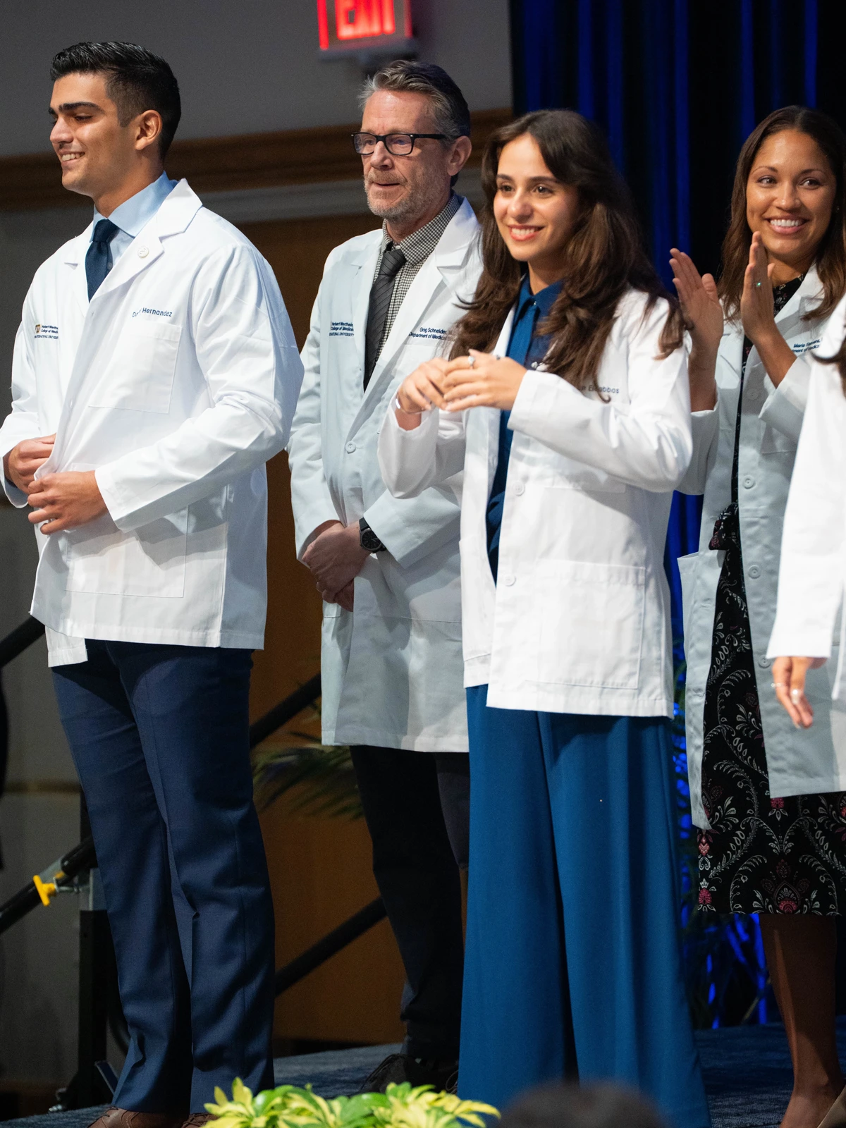 students being given white coats