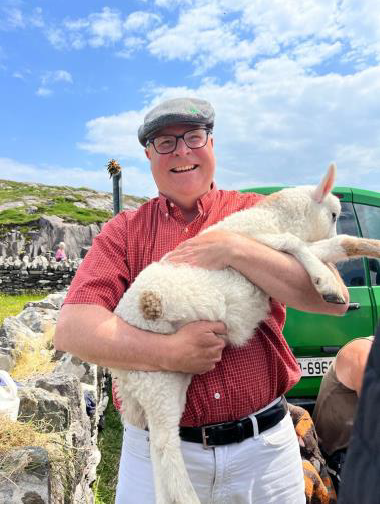 James Sutton holding a sheep